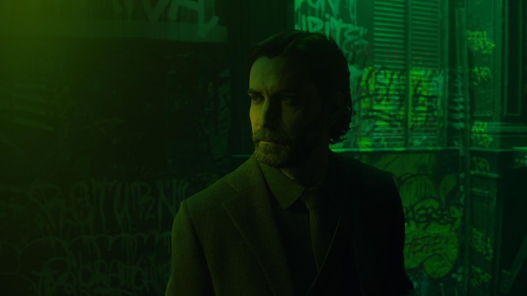 A screenshot from Alan Wake II where Alan is trapped in the Dark Place version of New York