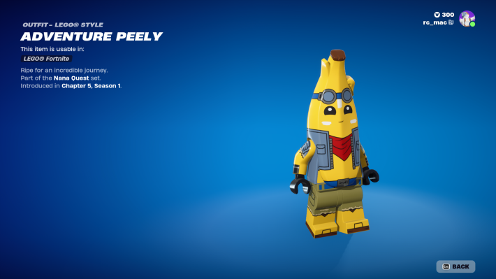 The Fortnite character Peely as a Lego character: a yellow banana with arms and legs, wearing brown pants, a blue vest, a red bandana, and blue goggles on his head.