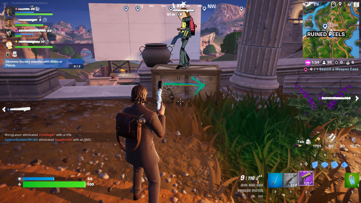 Alan Wake in Fortnite, staring at a green arrow spraypainted on a crate