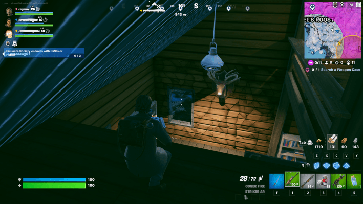 Alan Wake in Fortnite, on the top floor of a dark cabin. Illuminated under a bulb is a deer head hanging on a wall