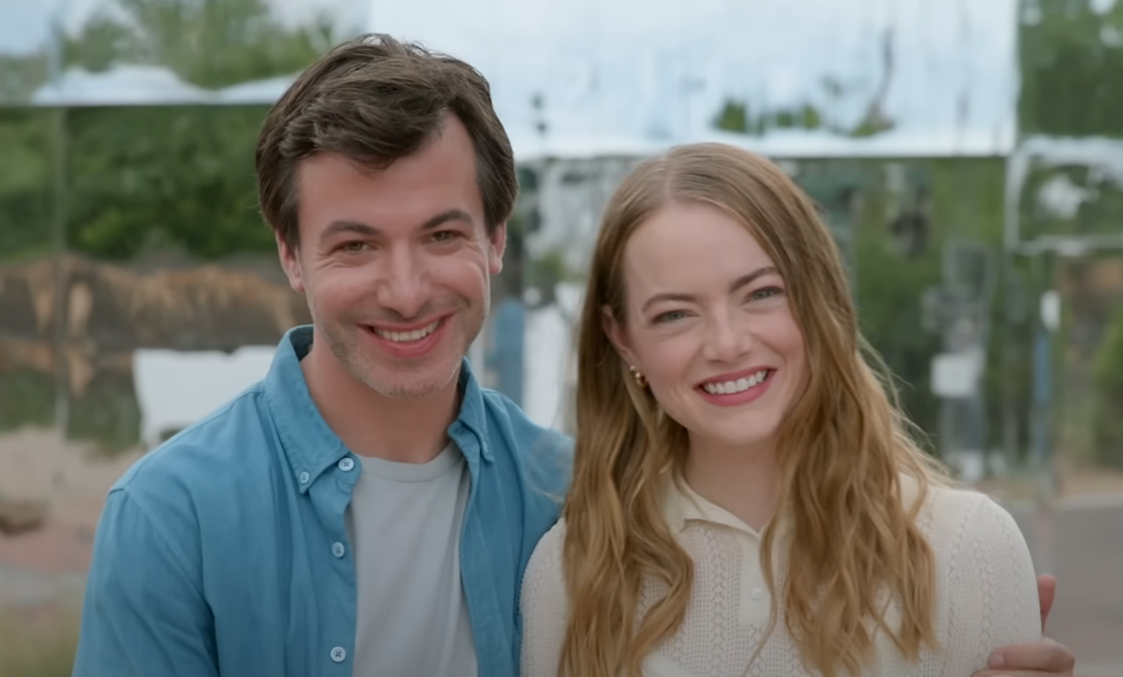 A screen shot of The Curse, featuring emma stone and nathan fielder smiling way too big into the camera