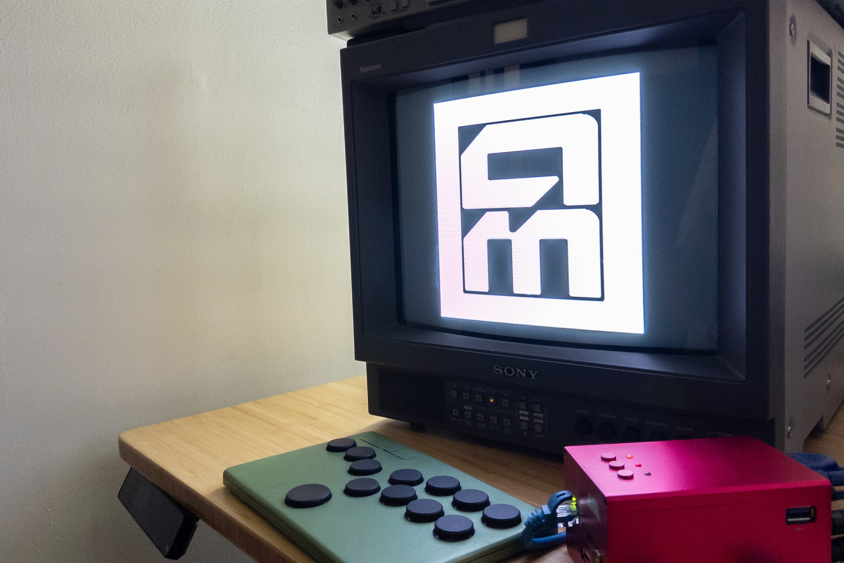 A MiSTer and Flatbox controller streaming the Aftermath logo on to a CRT.