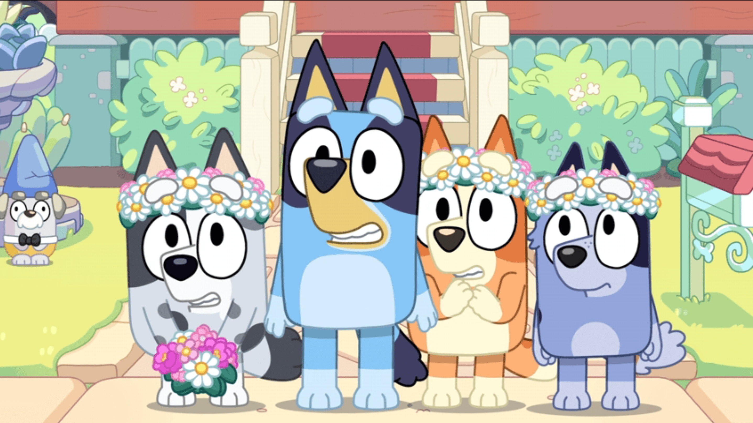 A screenshot from "Bluey:" four cartoon dog chidlren in flower crowns grimacing nervously