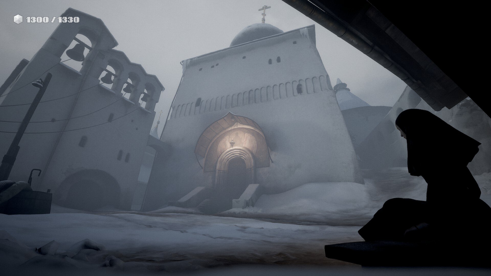 A screenshot from the game Indika: a nun in all black sits in the corner of a courtyard of a snowy monastery.