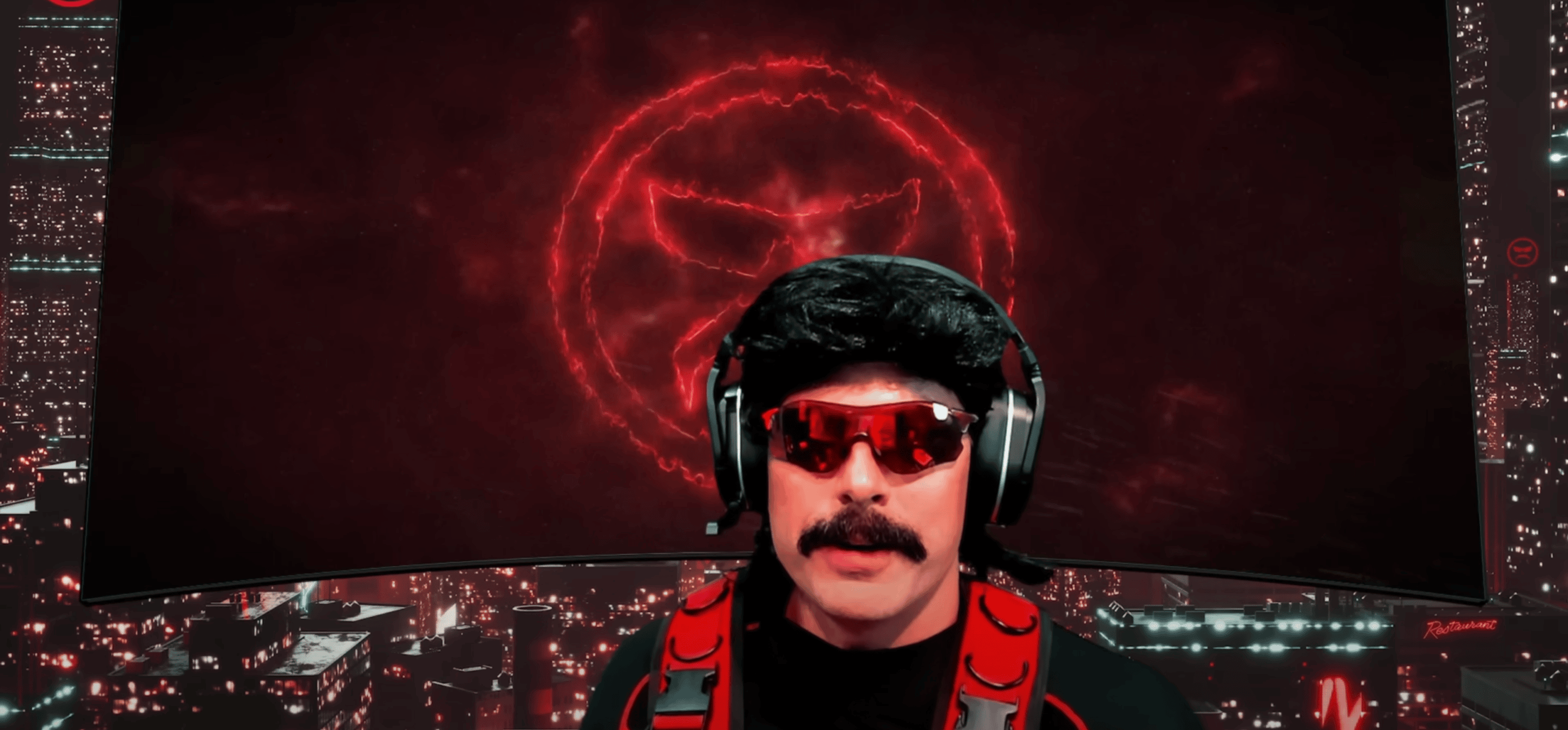 A screenshot of streamer Dr Disrespect: a man with a mustache wearing sunglasses in front of a red background