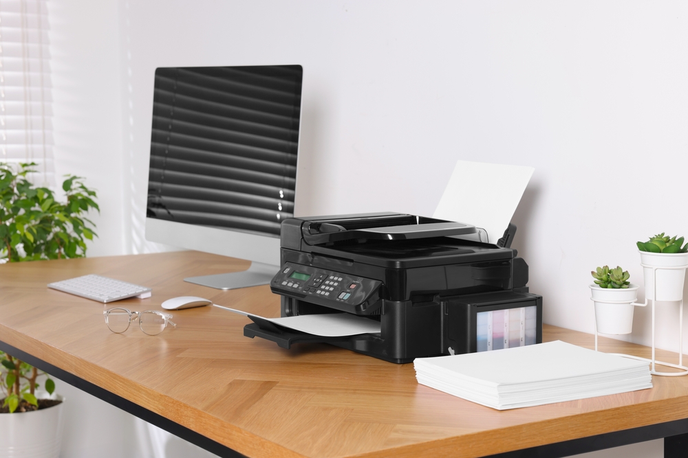 A printer sits on a desk.