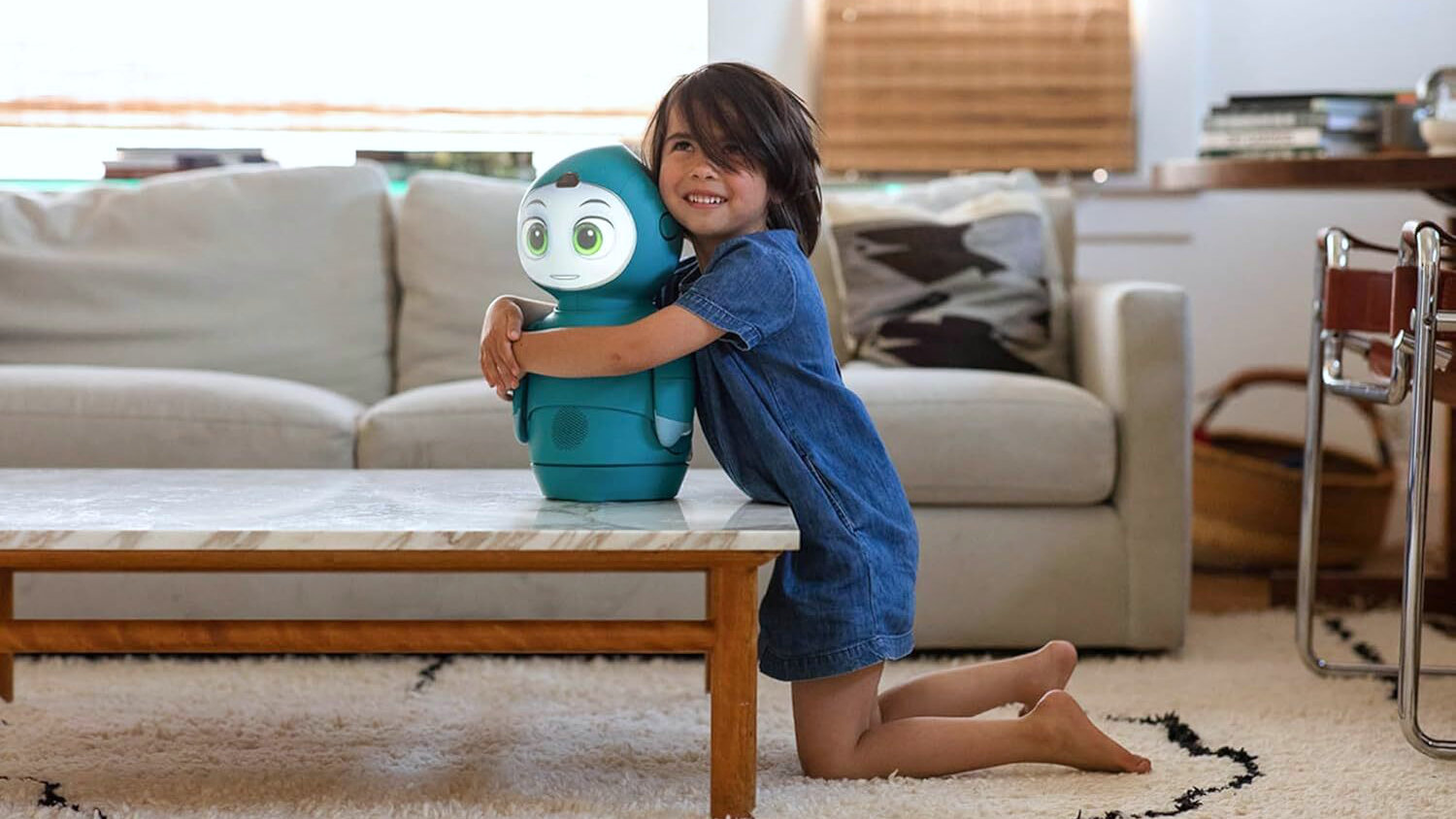 A child embracing a Moxie robot.