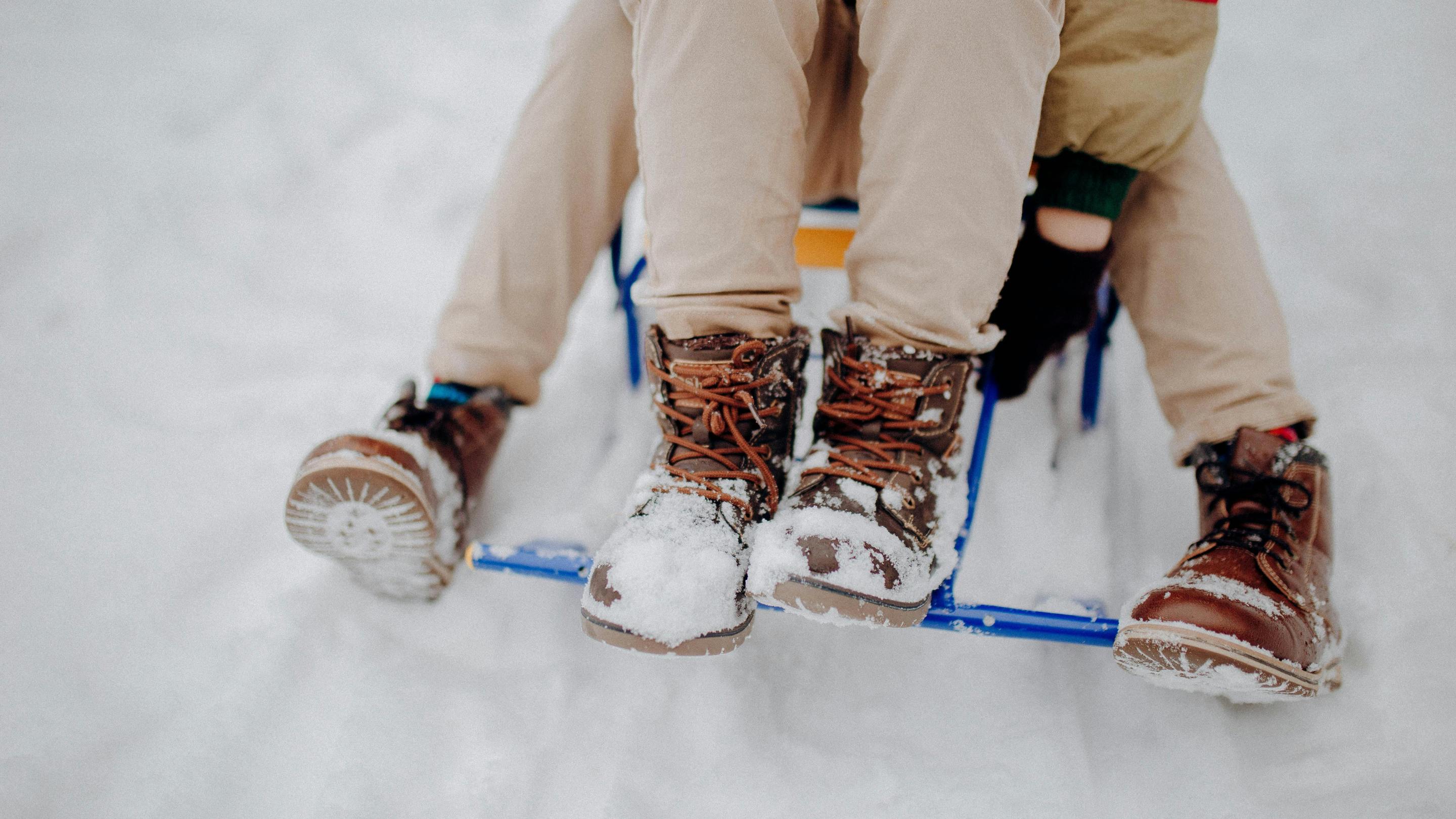 The boots of two people on a sled