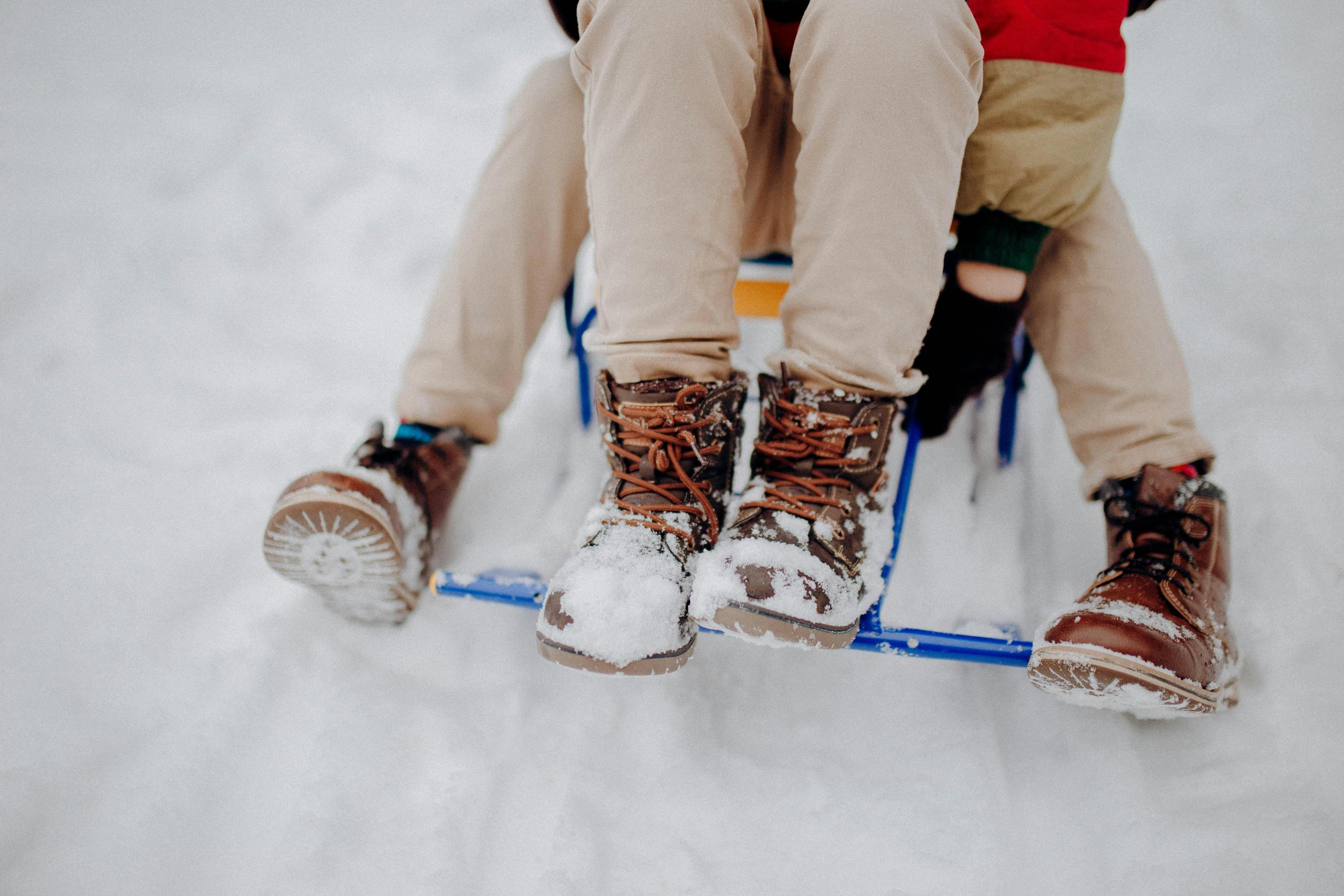 The boots of two people on a sled