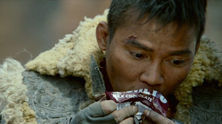 Tony Jaa chowing down on a Hershey's candy bar.