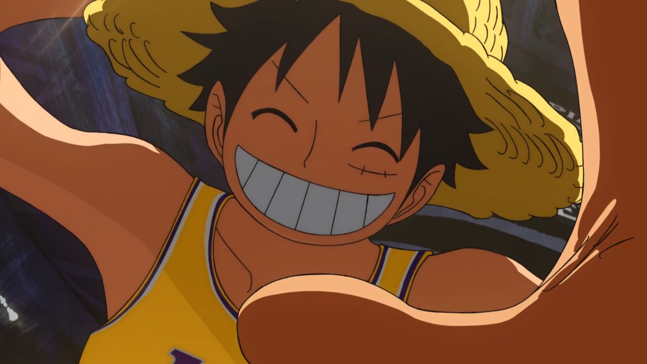 One Piece's Monkey D. Luffy smiling at the courtside camera at a Laker's game.