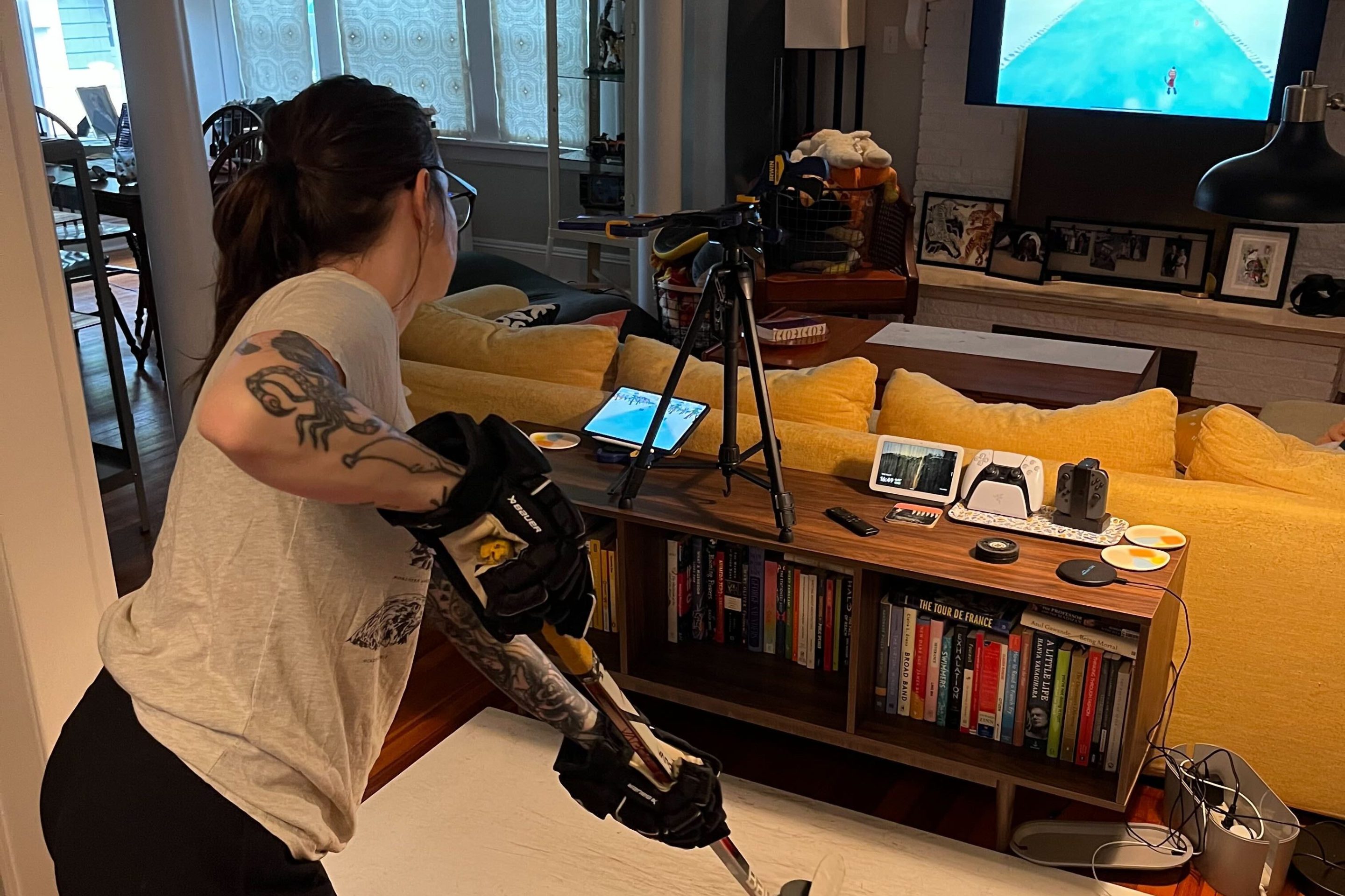 Nicole standing in a crowded space holding a hockey stick