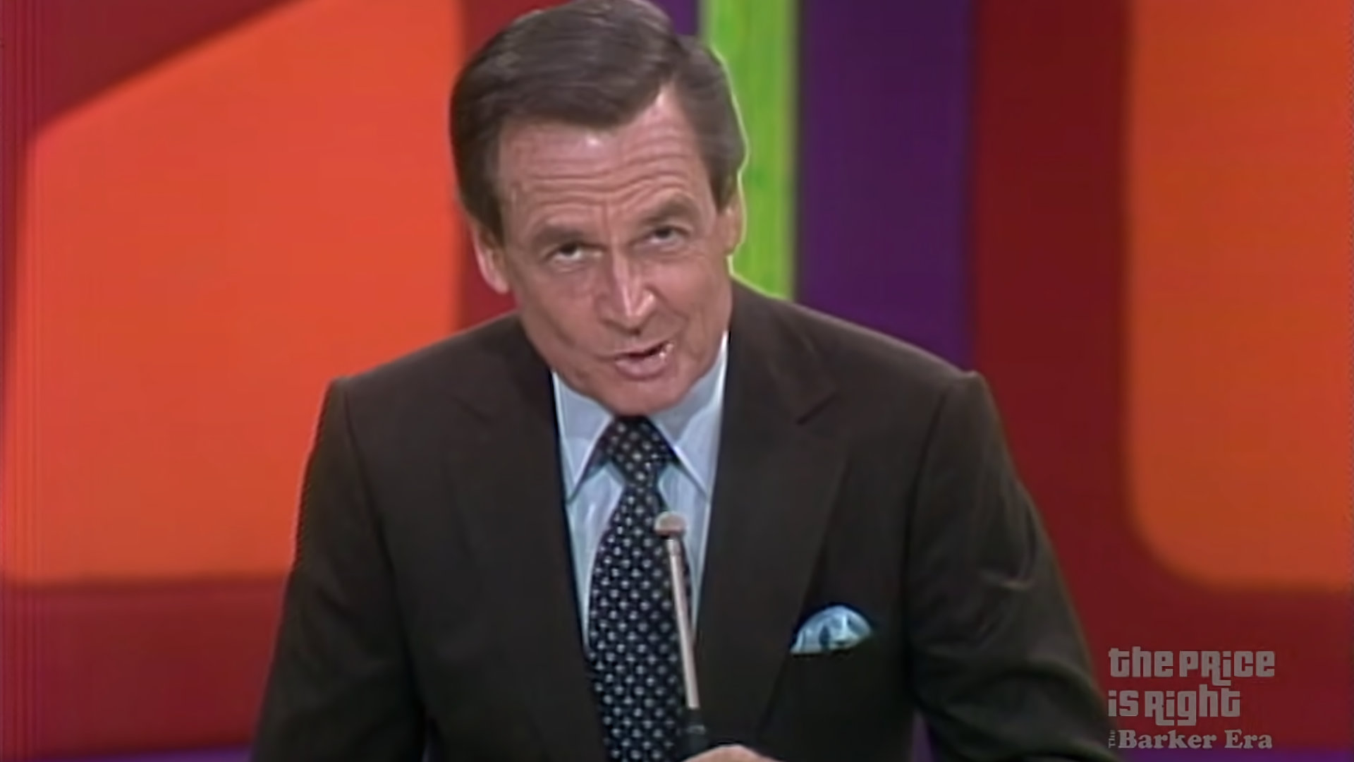 Bob Barker on The Price is Right with a long mic.