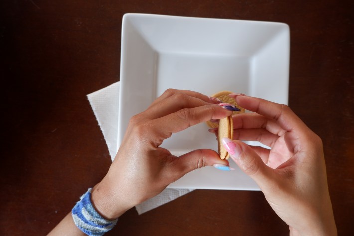 Twisting an Oreo cookie apart.