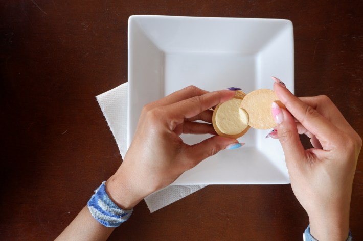 Scraping the creme off of an Oreo cookie using its other half.