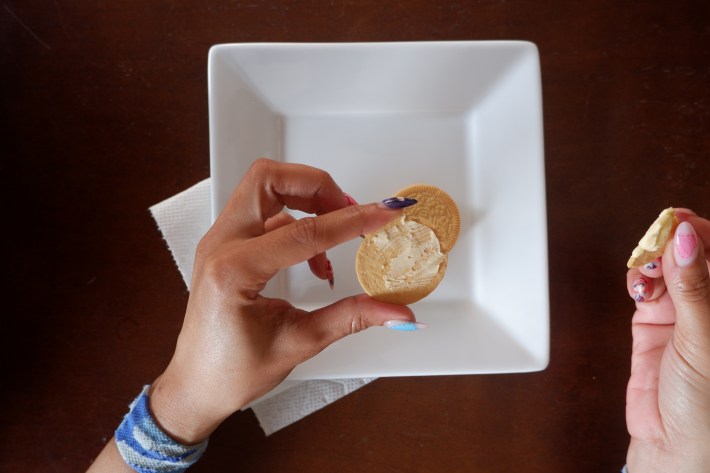 An Oreo cookie scraped and licked of its creme.