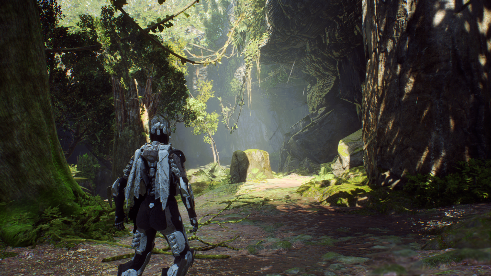 An Anthem character in a blue suit standing in a lush forest