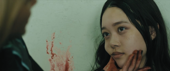 Mahiro wiping blood from Chisato's cheek in Baby Assassins 2: Babies.