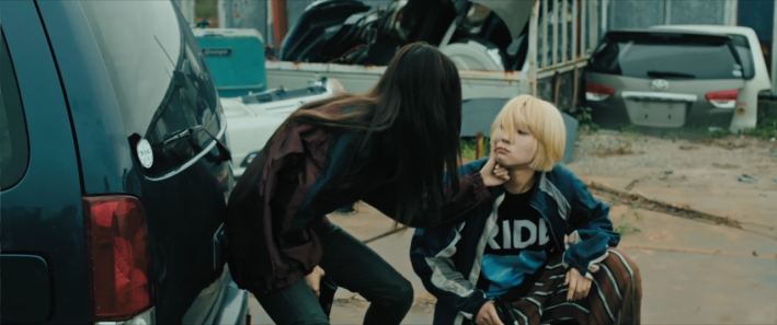 Chisato wiping blood from Mahiro's cheek in Baby Assassins: 2 Babies.