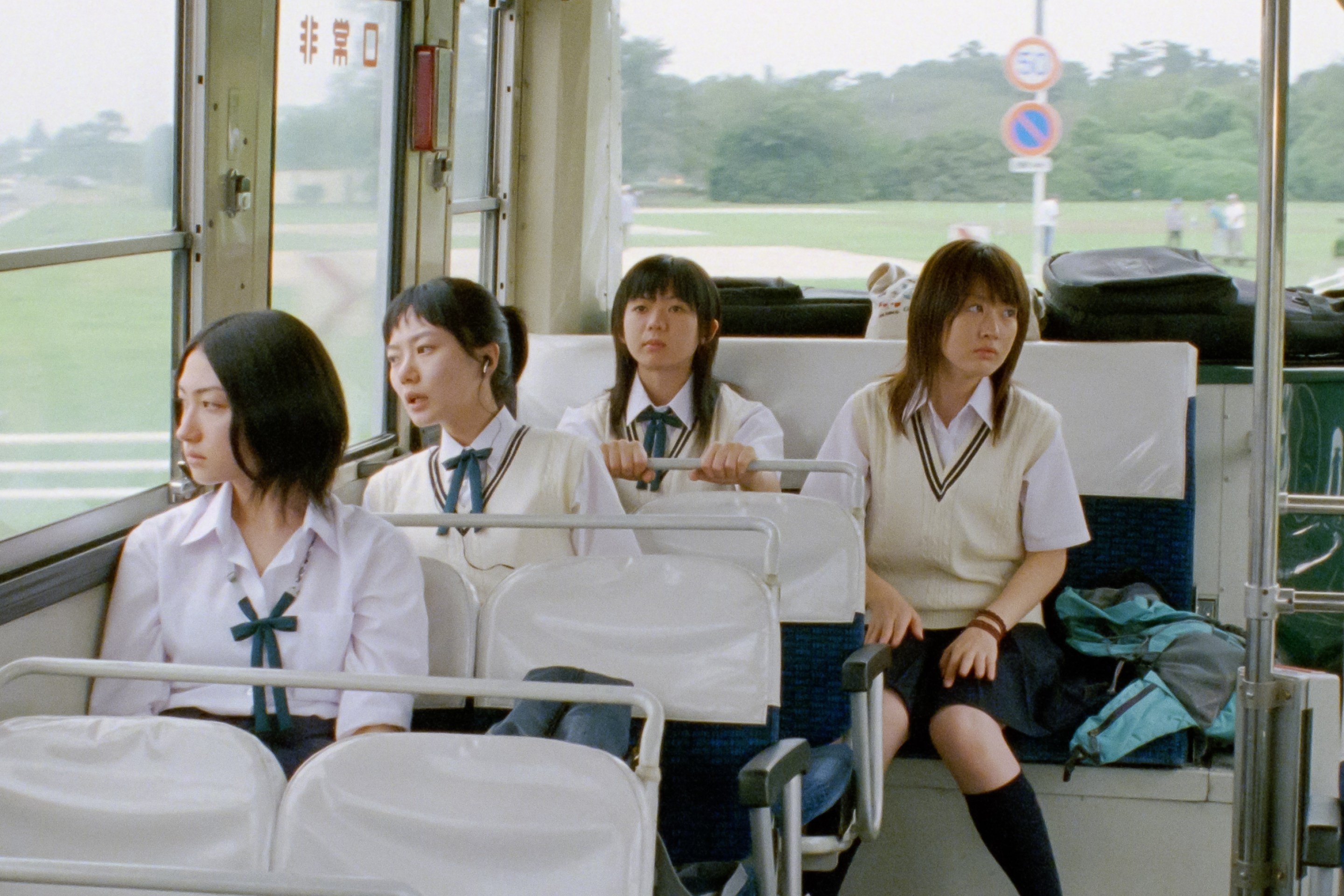 the four main characters of linda linda linda on a bus