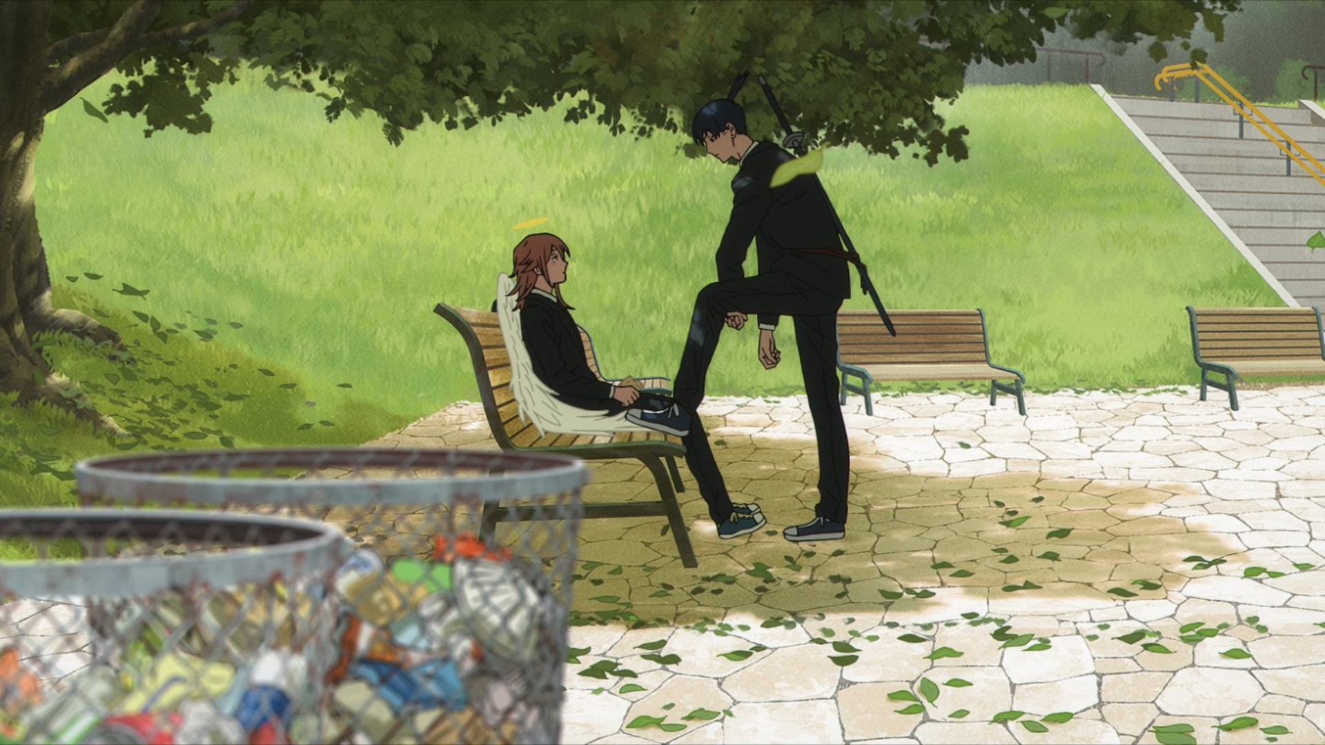 Chainsaw Man -- The Movie: Reze Arc still of Aki placing his foot by Angel Devil while he sits on a park bench.