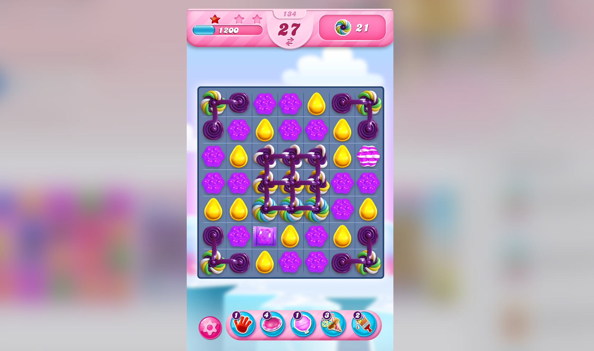 Screenshot of Candy Crush Saga, showing the matching game's purple board
