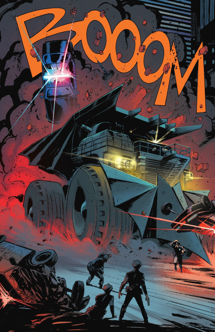 The Batmobile, shaped more like a construction vehicle than a car, barreling through plumes of smoke and flames, tossing a cop car in its wake.